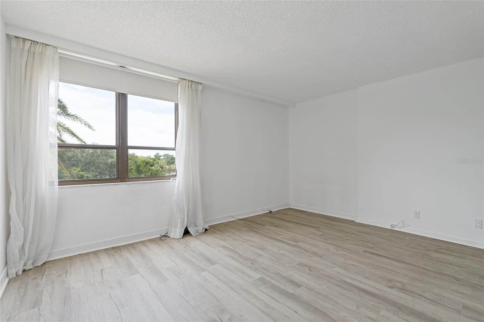 Primary bedroom has nice wood floors.