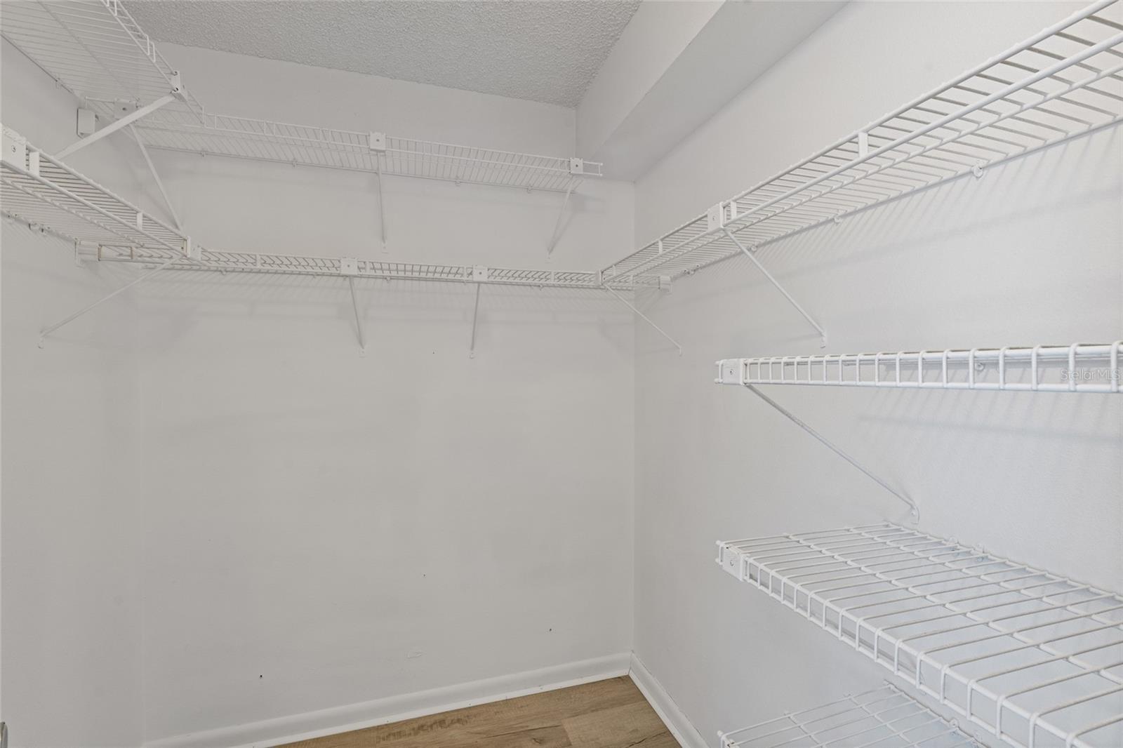 Walk-in closet in primary bedroom.