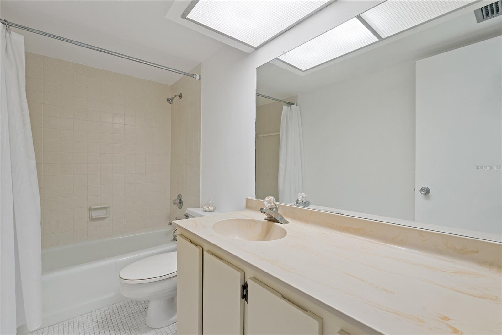 Second bathroom with bathtub/shower combo.