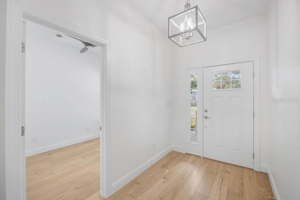 Front door and peeking into bedroom 4/office