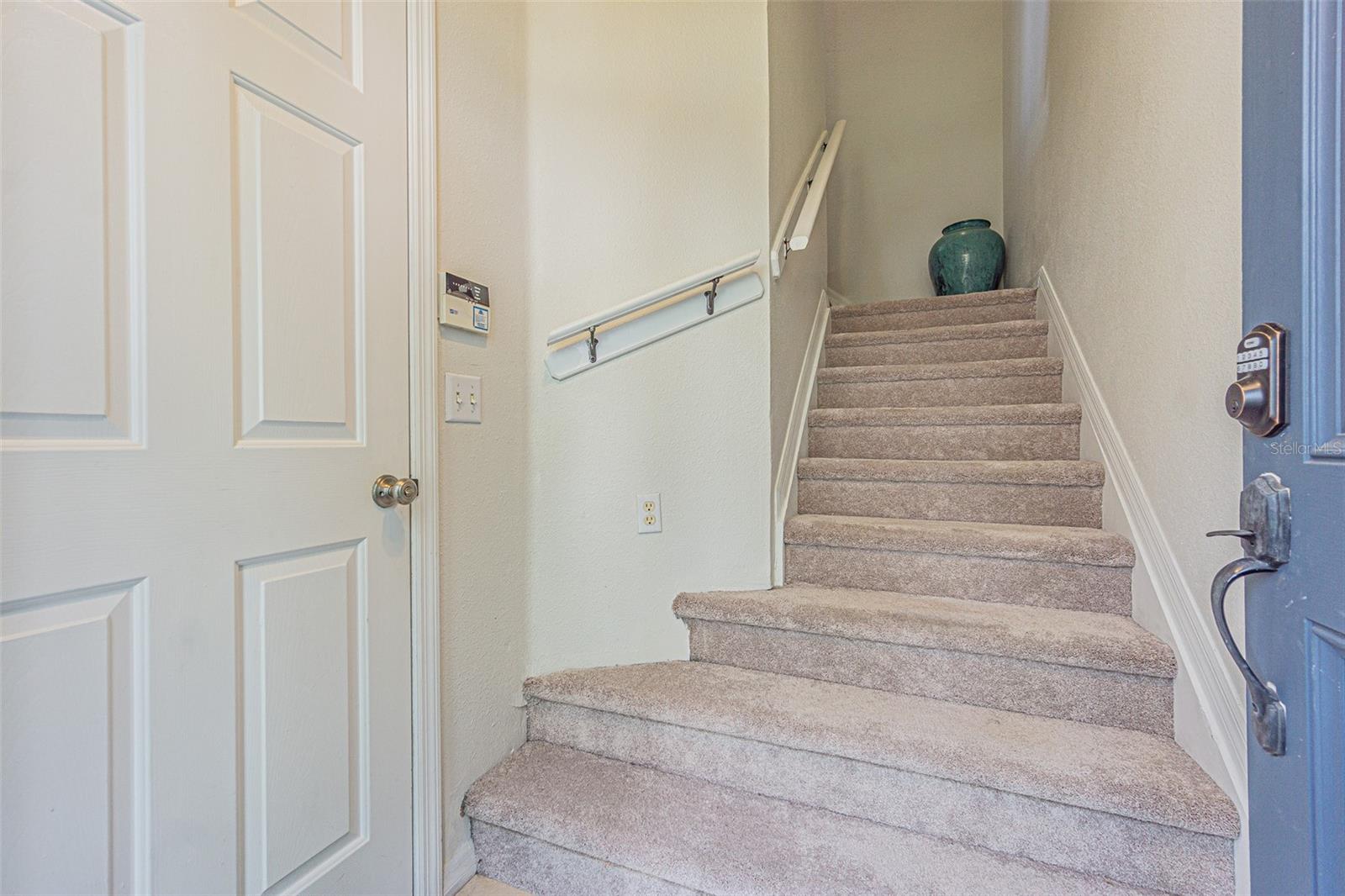 stairway from entry door up. garage to the left