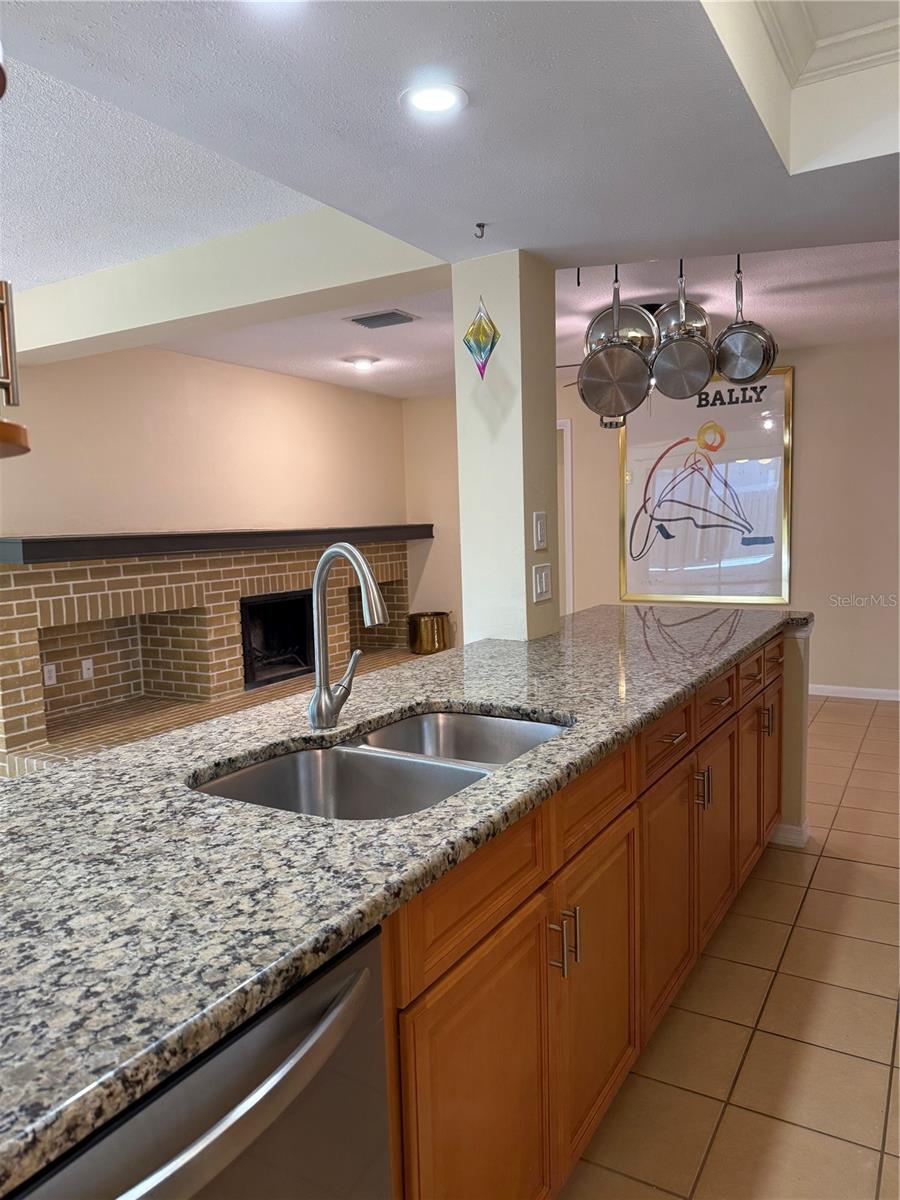 Kitchen island with great granite counter top & SS sink looking into FRoom