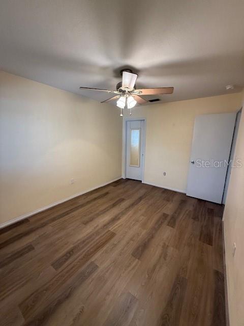 Primary bedroom viewing walk-in closet door and hallway entry door