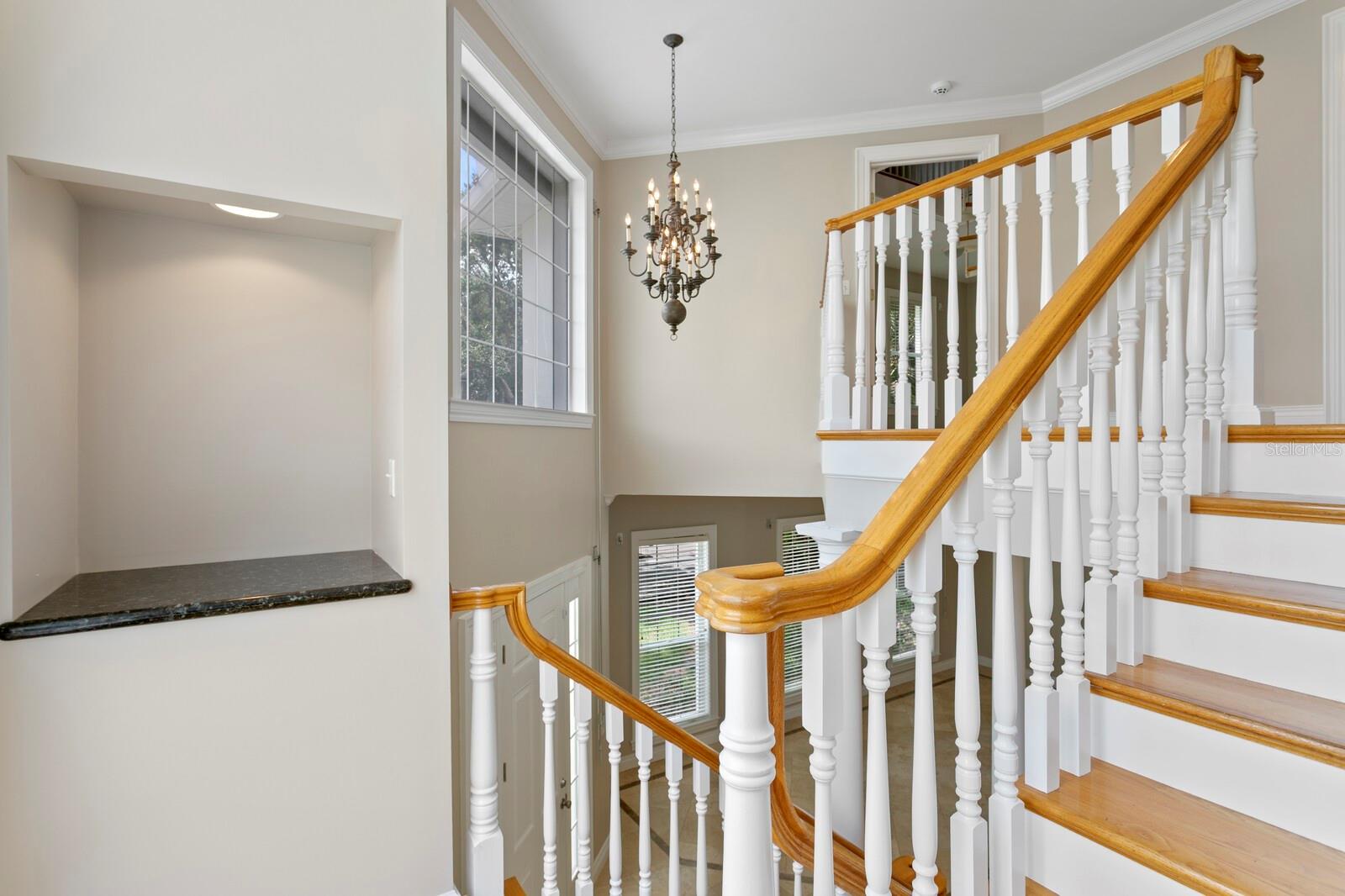 Split staircase with a large picture window and decorative art niche