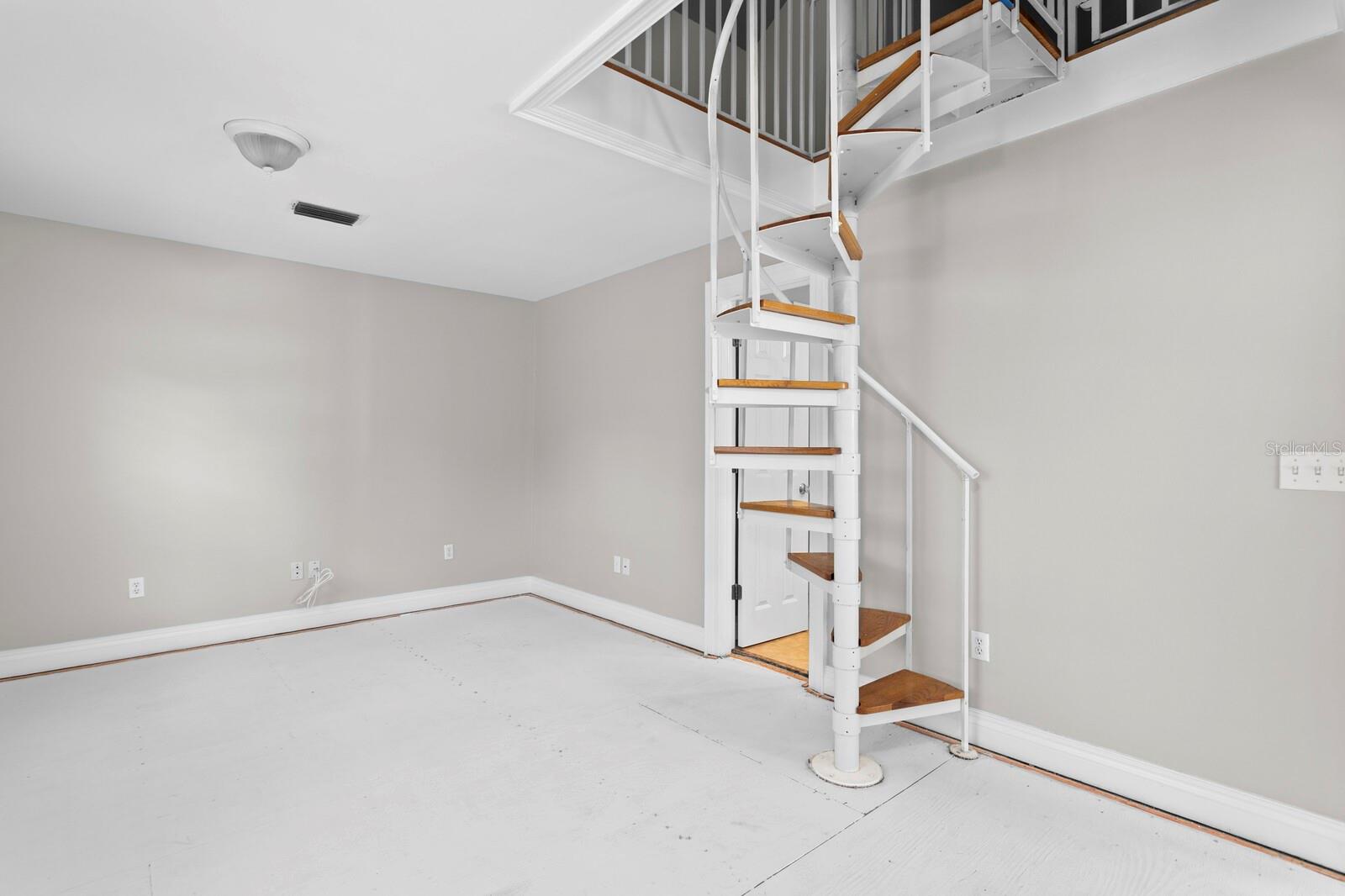 Spiral staircase in 3rd bedroom leads to large bonus room space