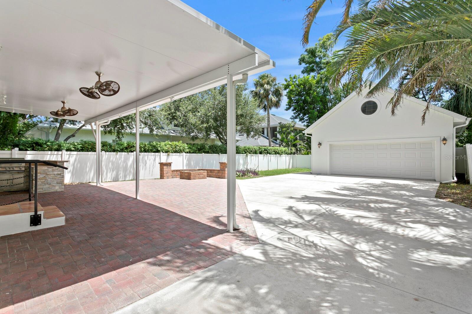 Side driveway leads to backyard and detached 2-car garage