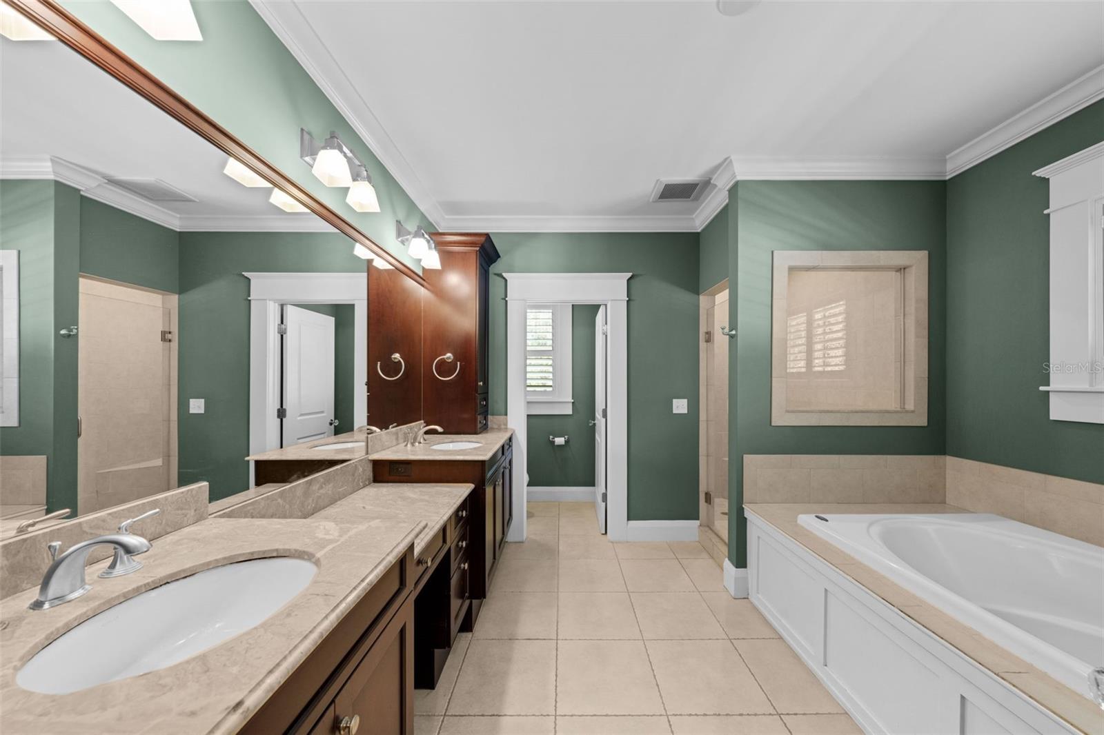 Primary bath features a garden tub, walk in shower and water closet