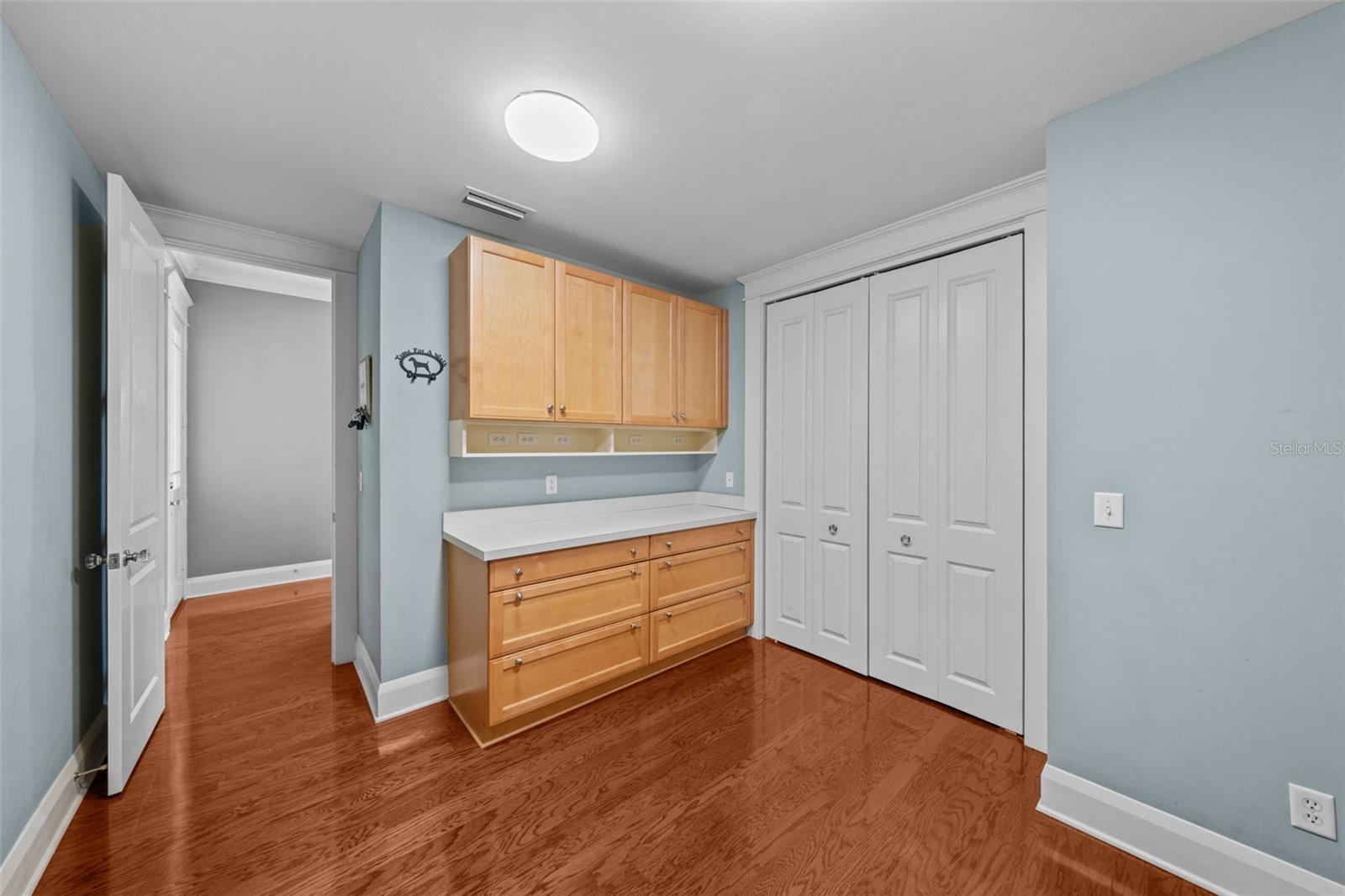 And an oversized mudroom with cabinets, utility closet