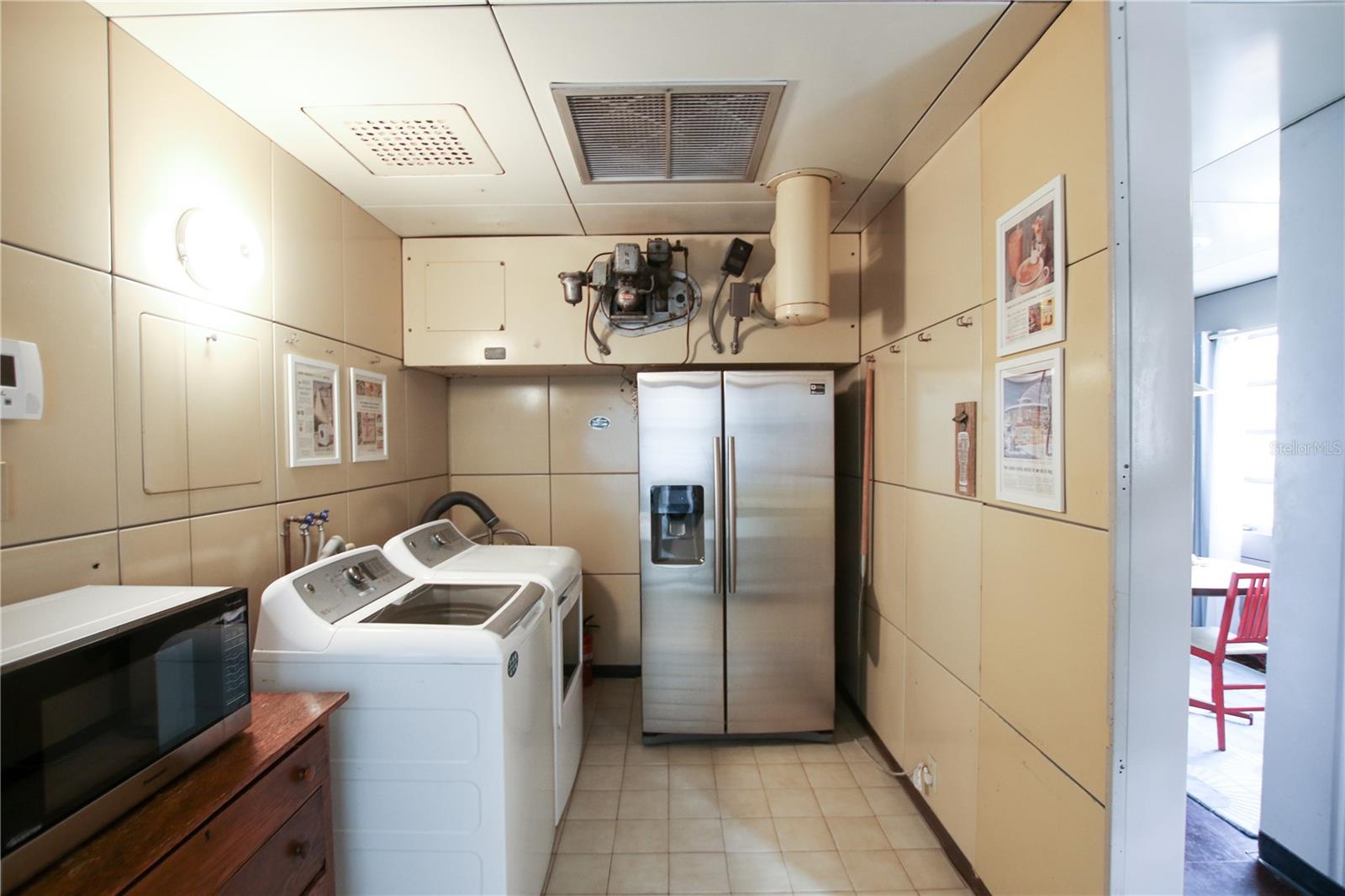the motor over the fridge is the old heating system.  Not used anymore but its cool.