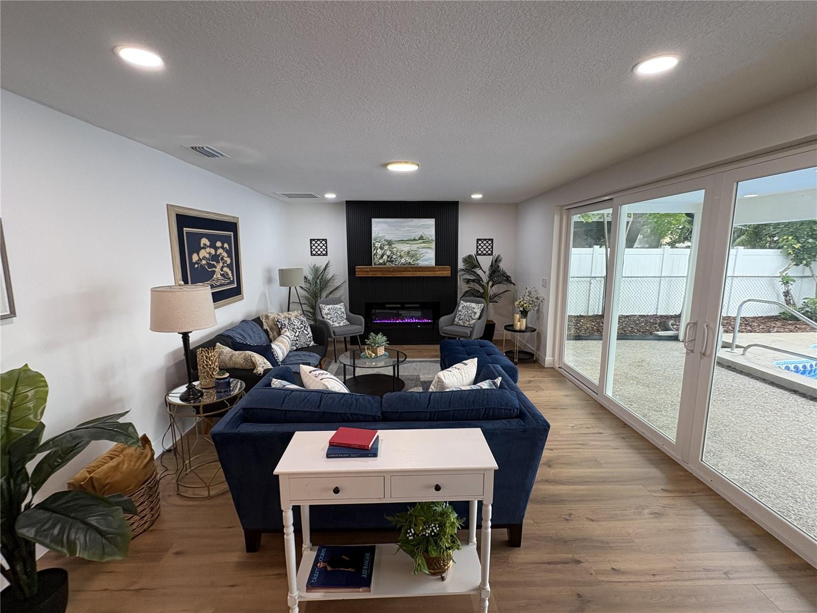 A stunning feature wall that includes an electric fireplace w/ remote.