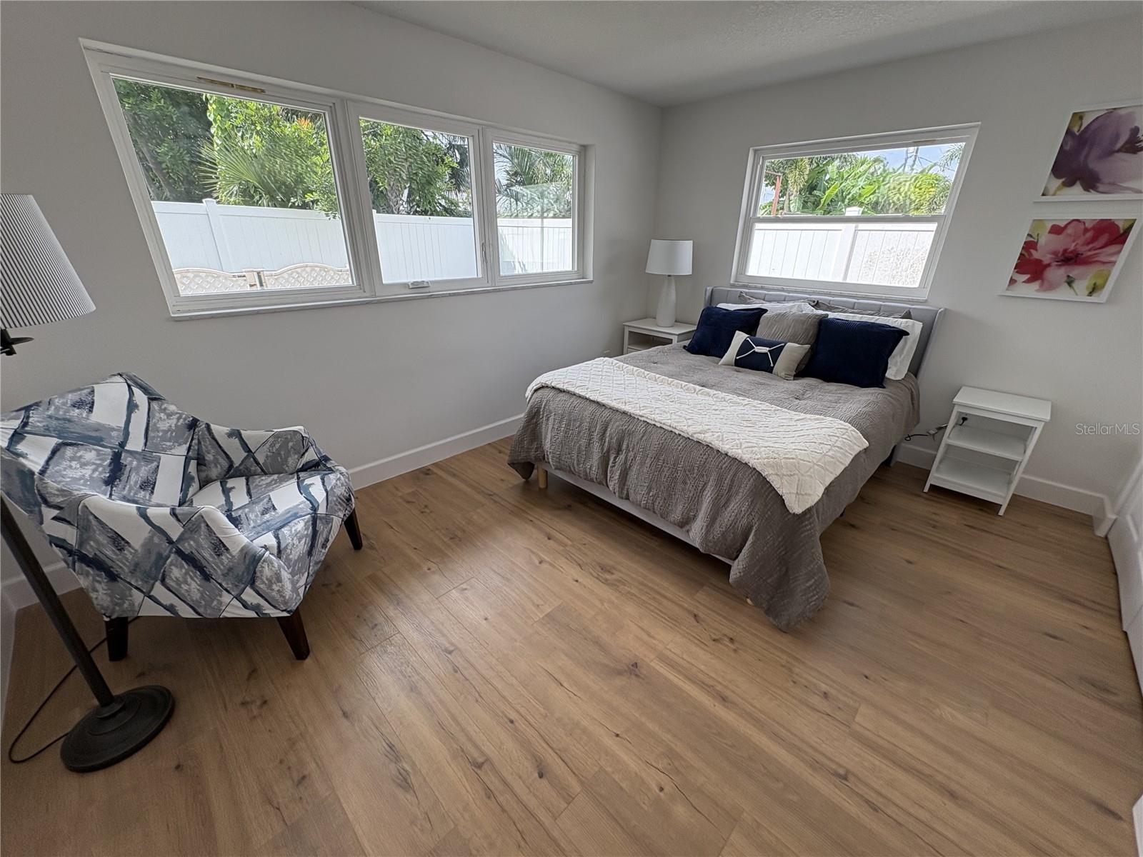 Another bedroom with lots of windows