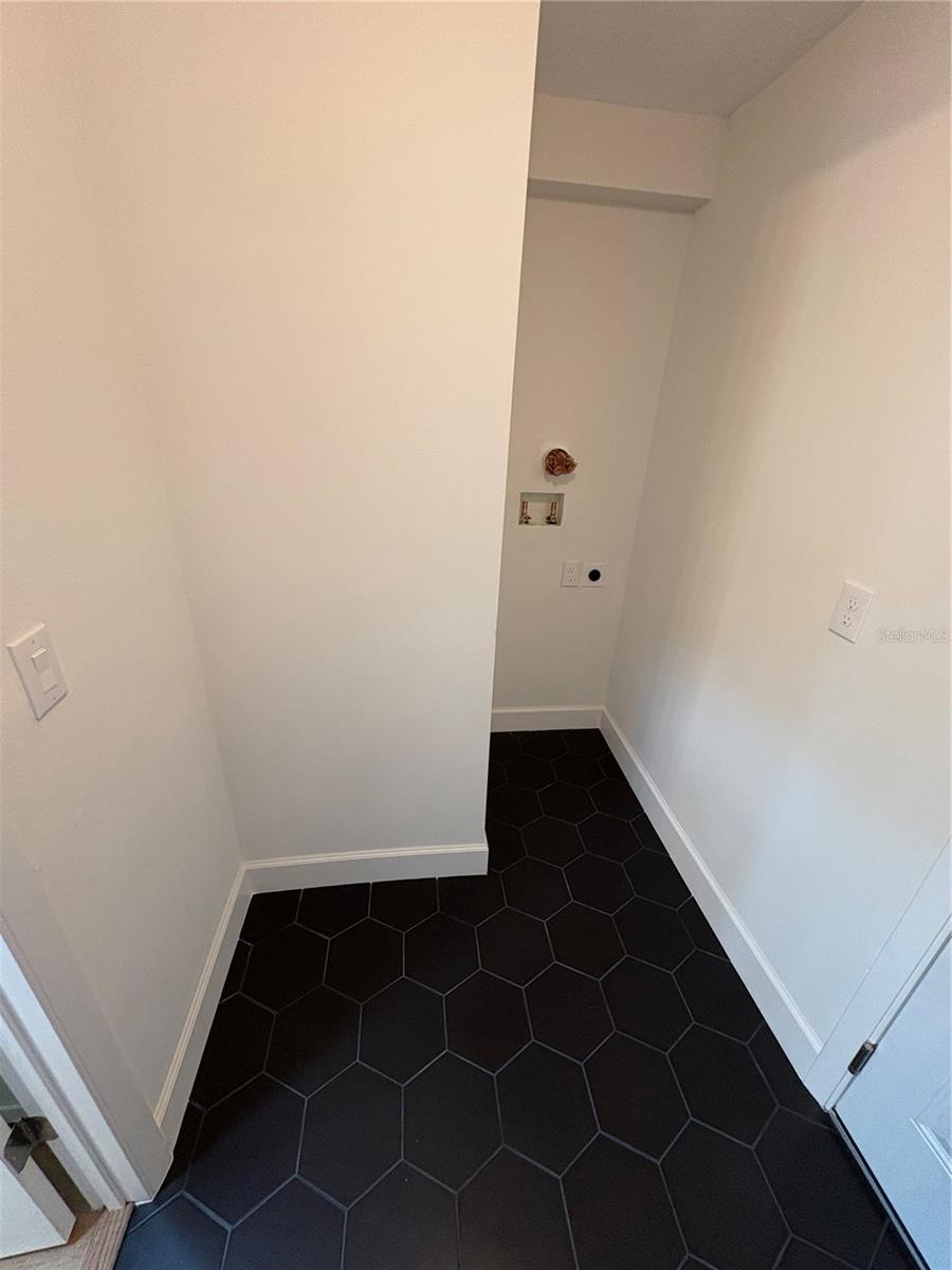Room for a stackable washer and dryer with more room for storage
