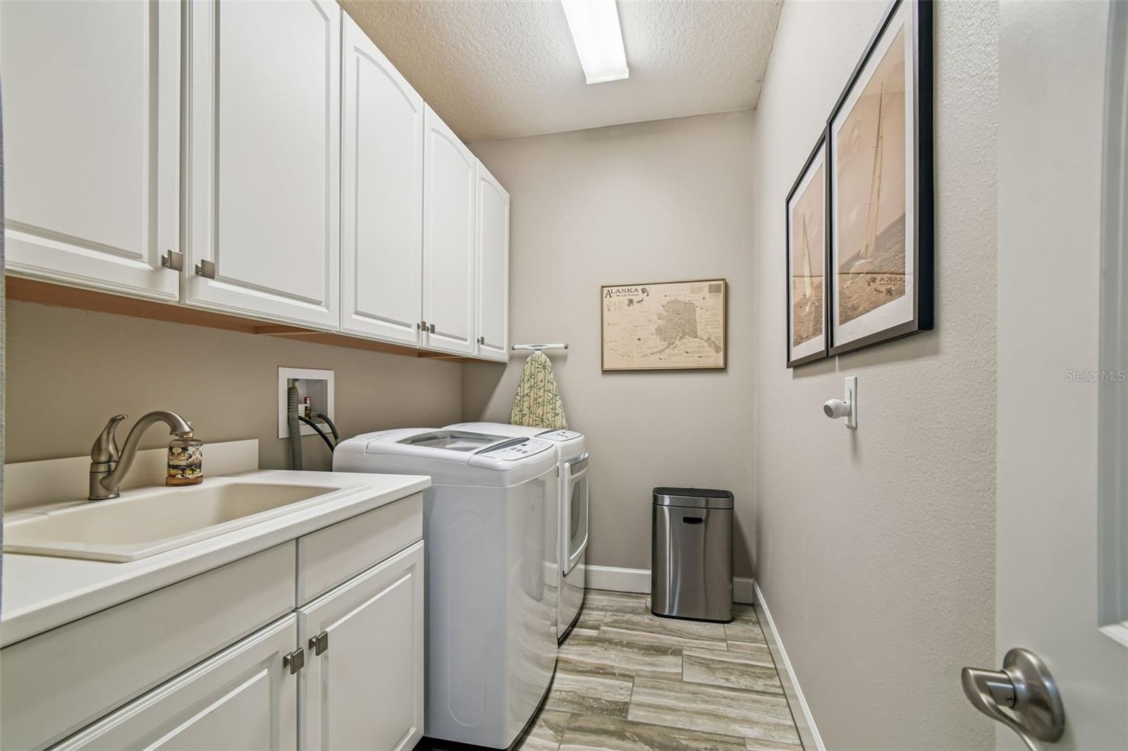 Laundry room with sink and cabinets