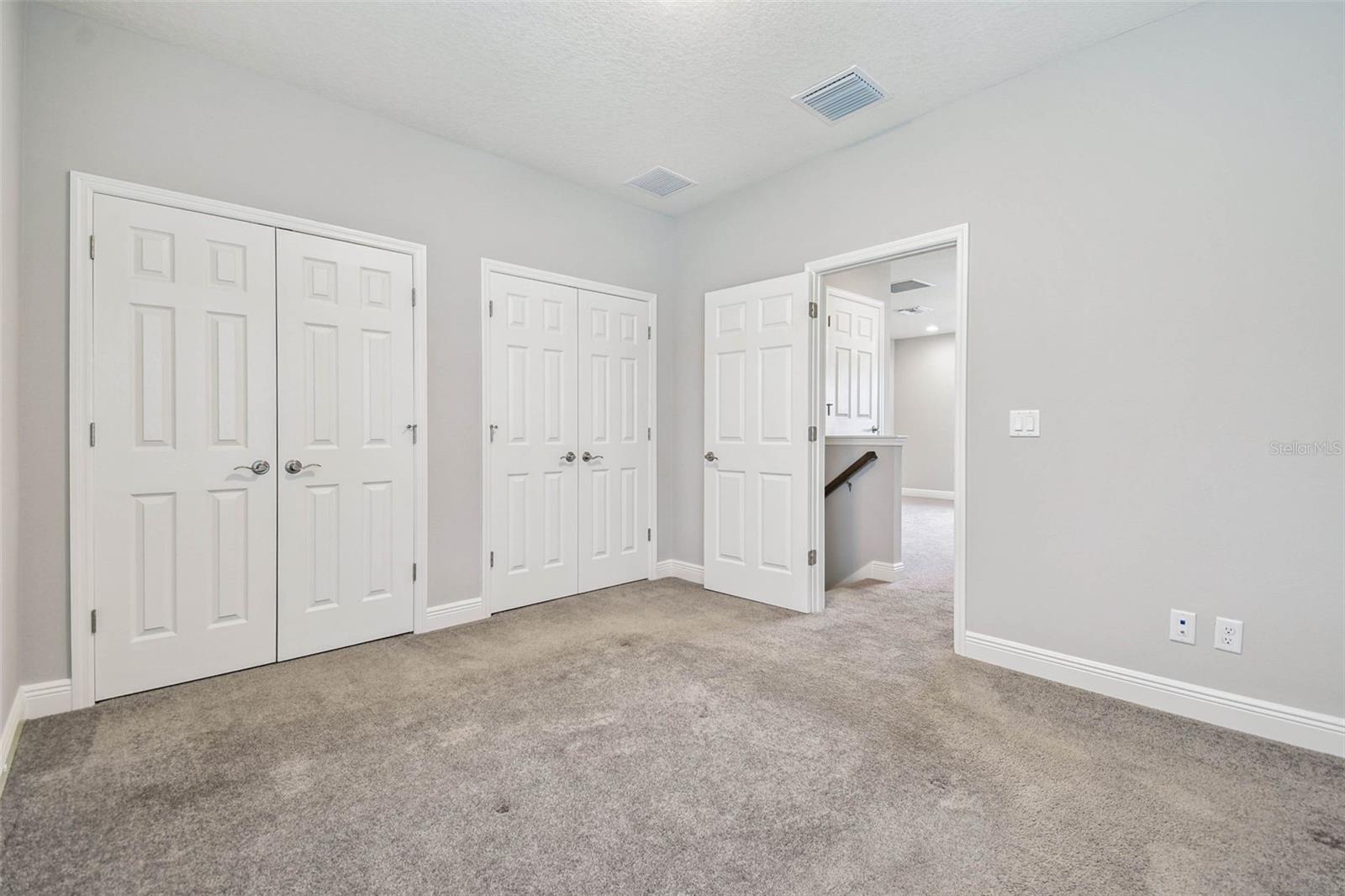 Spacious and private bedroom upstairs with storage