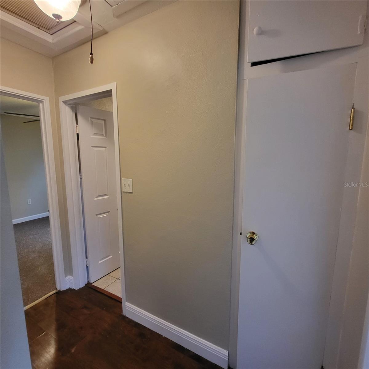 Hallway off living area features a storage closet & leads to 2 bedrooms and the full bathroom.