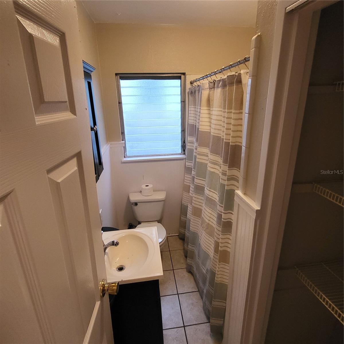Full bathroom with tub/shower combo and roomy linen closet