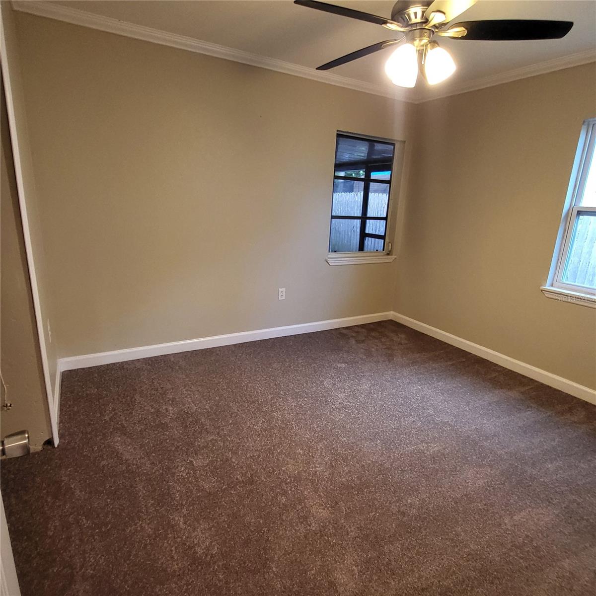 Middle bedroom on other side of the bathroom overlooks back patio
