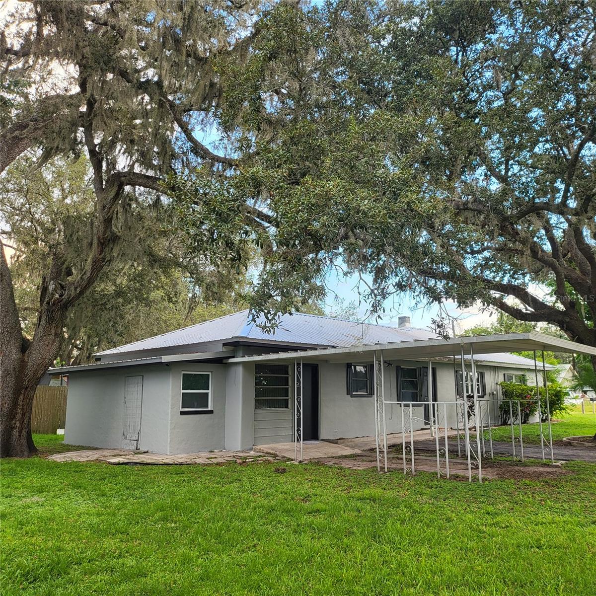 Convenient covered parking, 2 side entrances and an exterior storage room