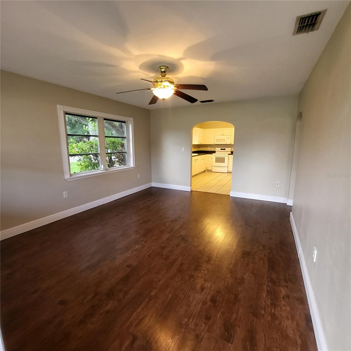 Enter front door into the freshly painted living room with laminate flooring.   Two bedrooms and full bath off hall to the right.