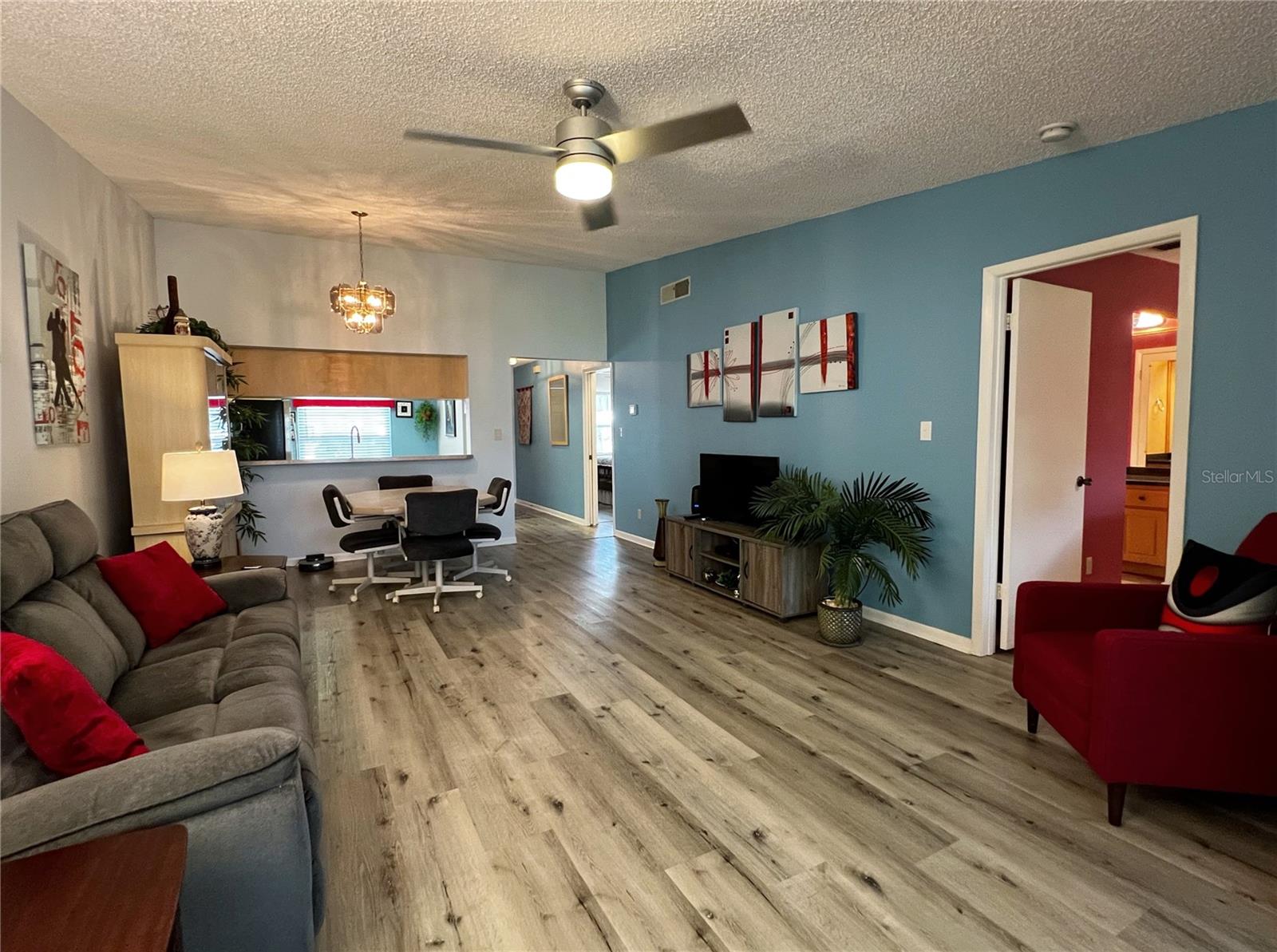 View of the living room looking towards the front of the condo, with the primary suite off to the right.