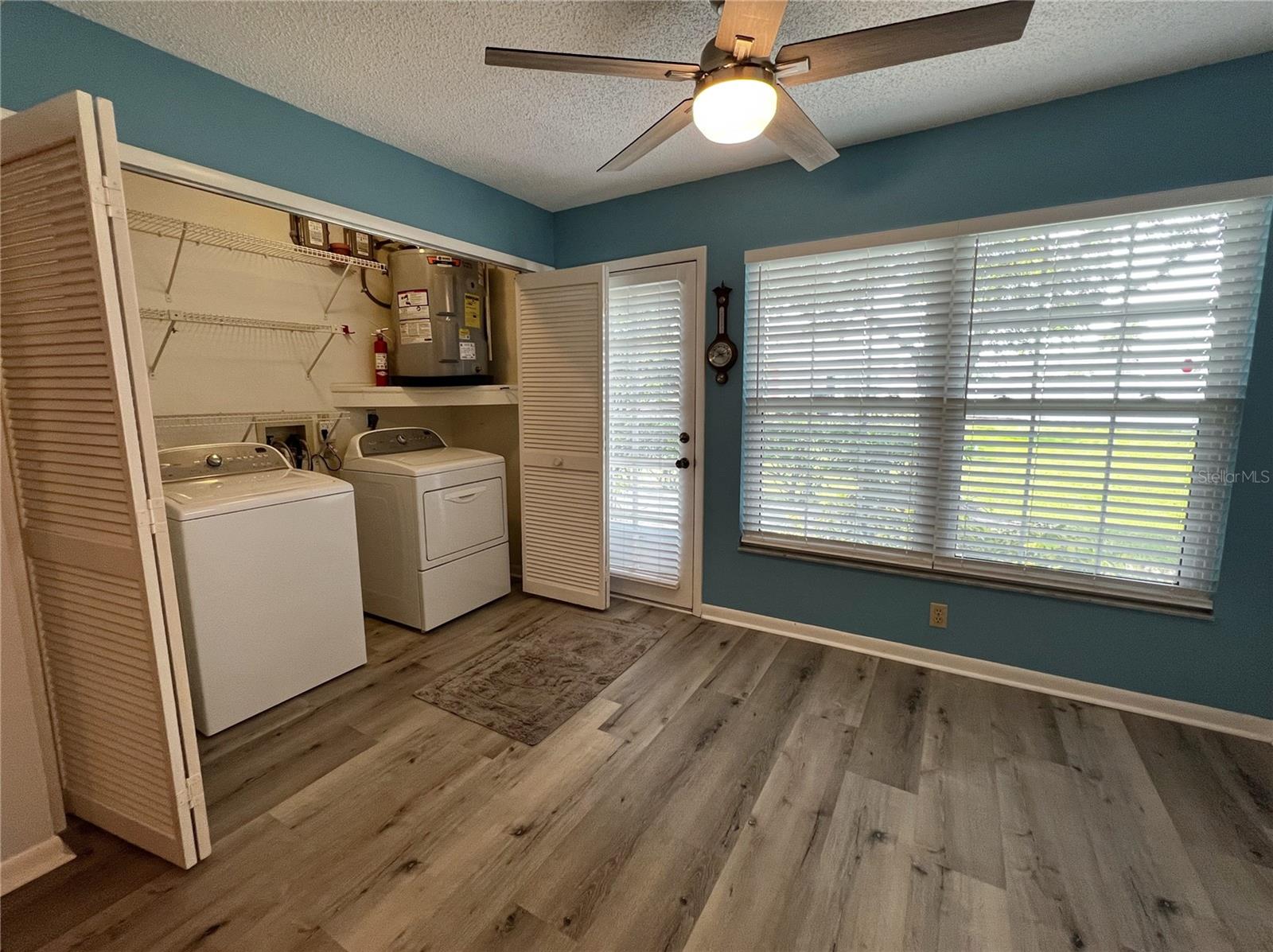 Sunny Florida room with a large closet for your washer and dryer and storage space.