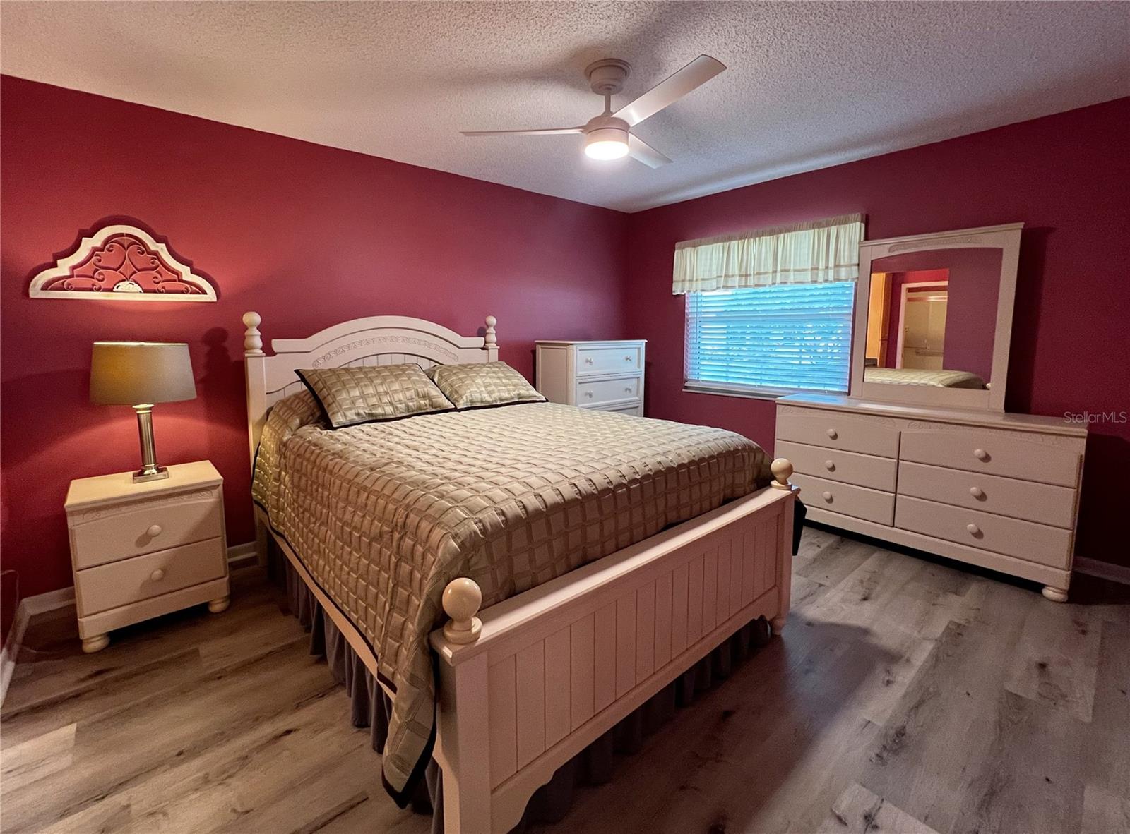 Primary suite with a private attached bathroom and a walk in shower.