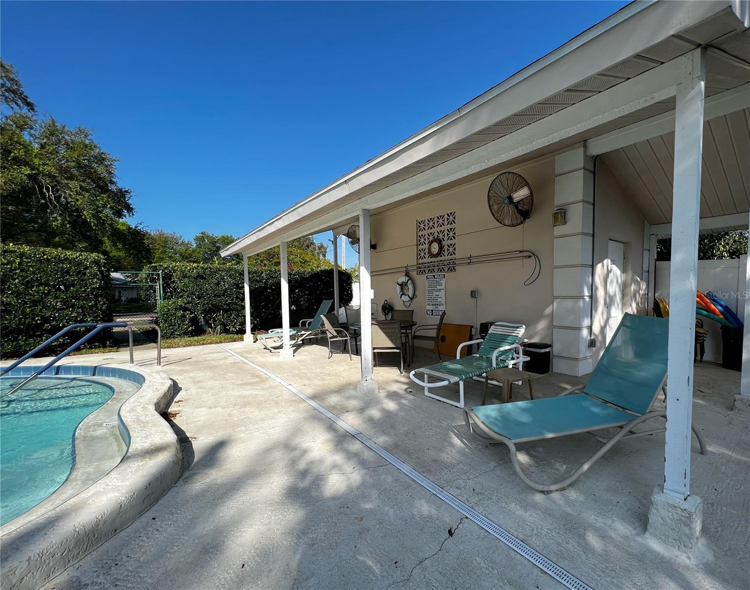 View of the covered patio by the pool with men's and women's bathrooms, too.