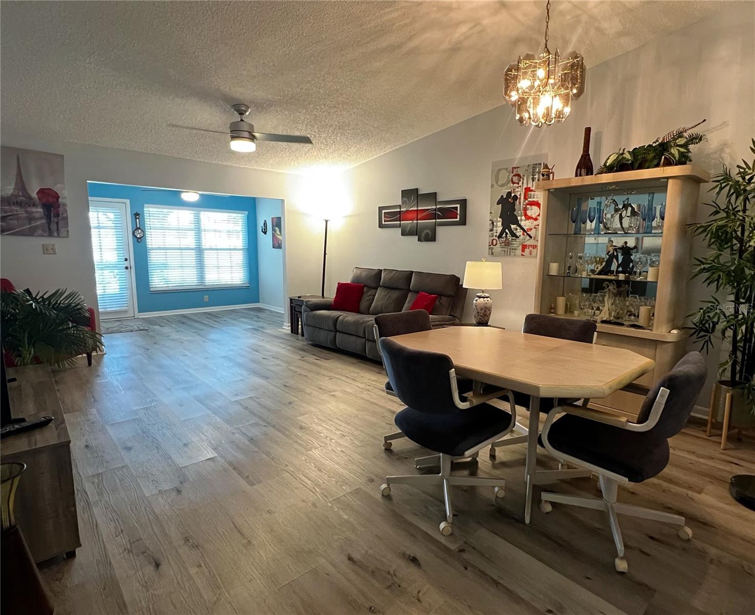 Dining and living room combo, with a view of the Florida room in the back of the condo.
