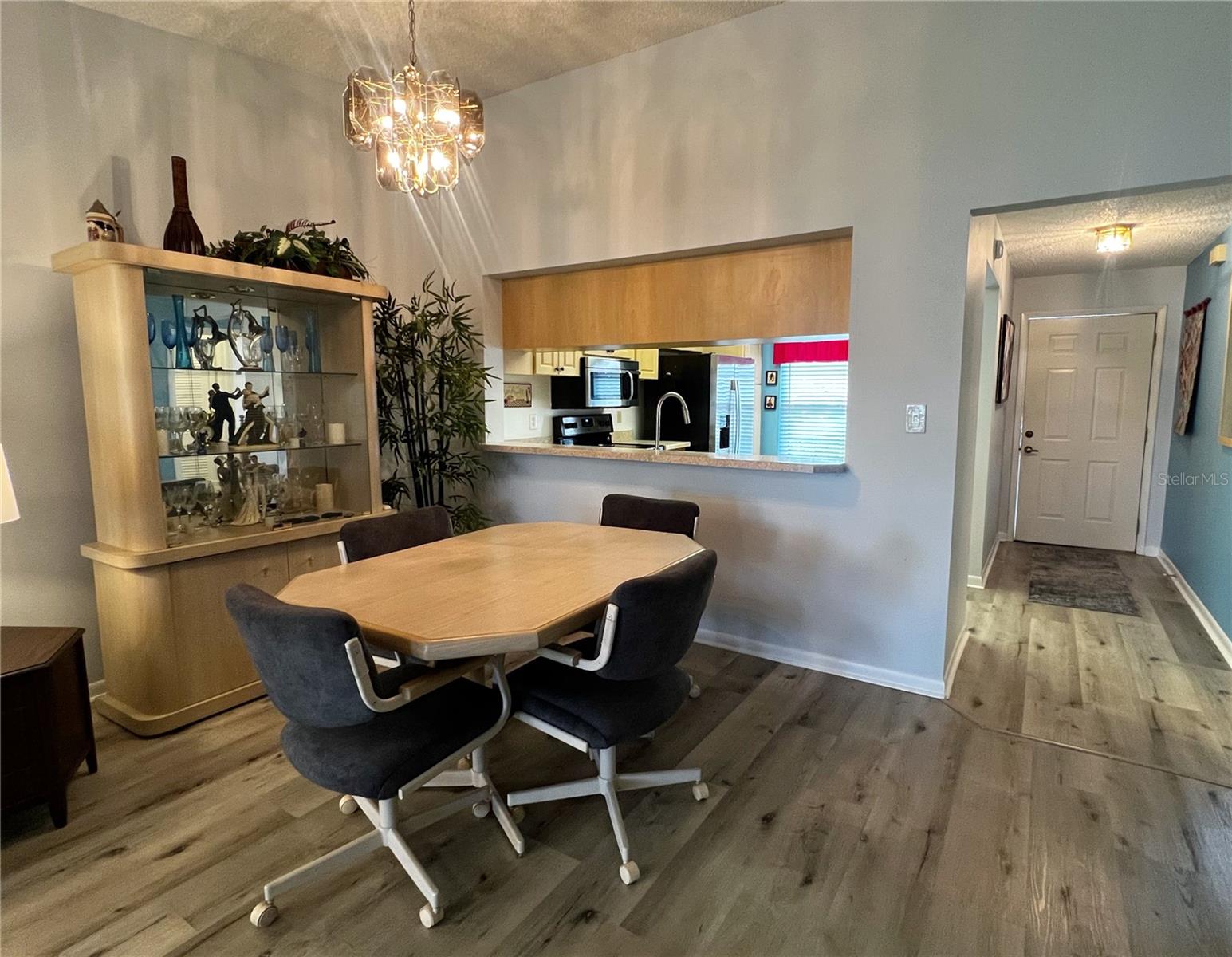 View of the dining room looking towards the front entrance door and the kitchen.