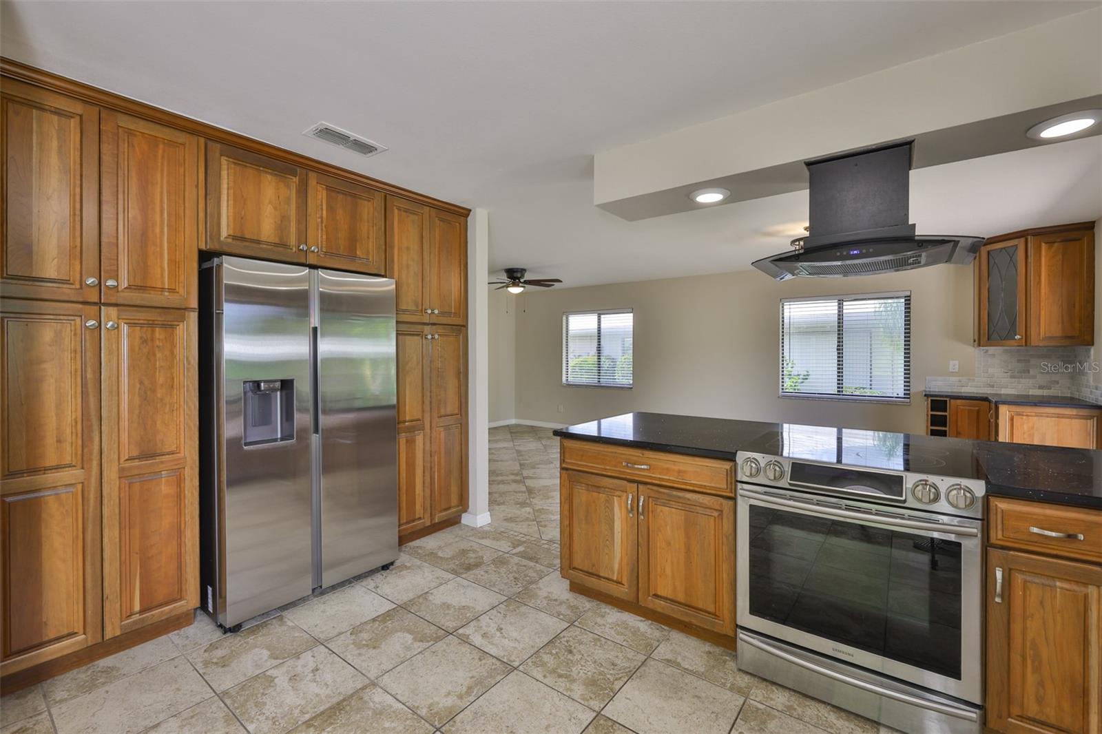Tons of custom cherry wood cabinets with pull out drawers and an oven that can be a single or dual appliance.
