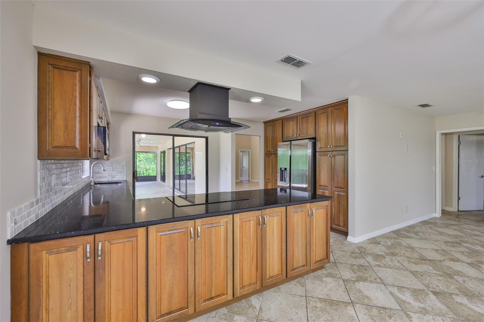 Stunning custom cherry cabinetry offer enormous amounts of storage