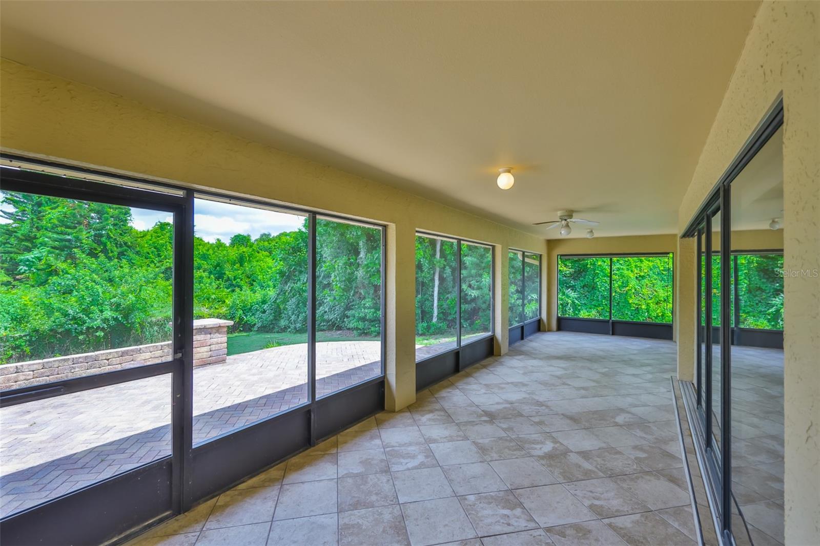 Stunning screened in lanai, with matching floor tile to the rest of the home is HUGE.  Whether you are sipping coffee on the back patio, or unwinding under the stars, peace and privacy are yours in every season.