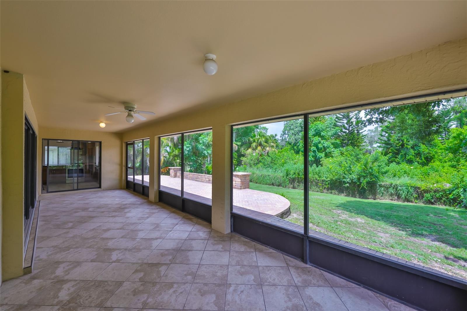 An extended Lanai/Florida Room with matching tile offers a stunning view. Perfect to fit a Jacuzzi or a large patio furniture set. What a view!