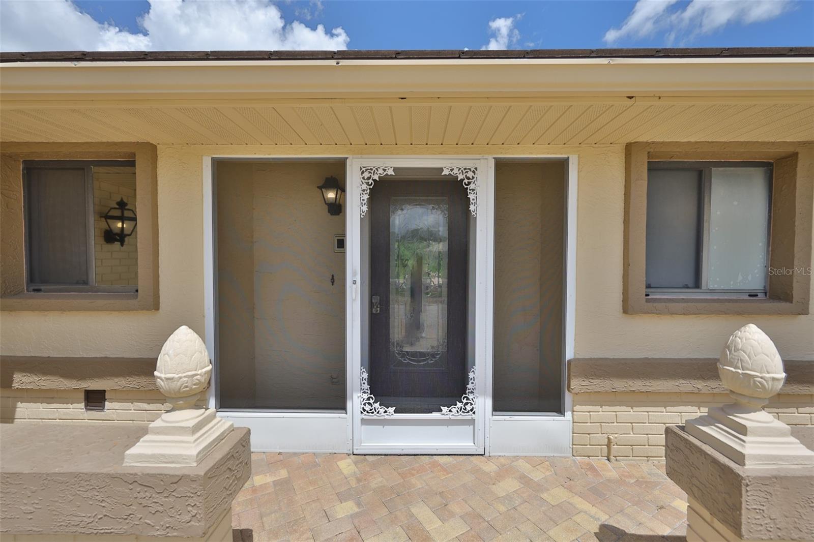 The front patio is paved and leads to the screened in front door, which is perfect for getting out of the elements or securing packages.  In the fall and winter, you can leave the lead glass front door open and allow sea breezes to flow into the home.