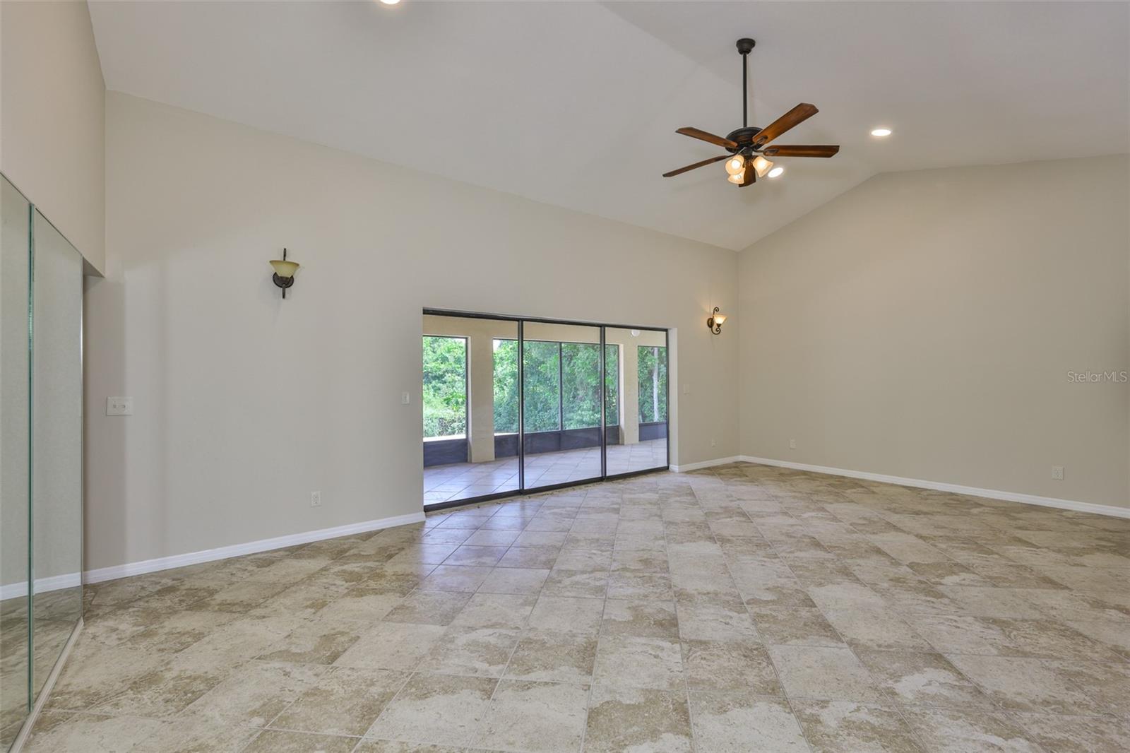 Inside, the home features inviting spaces, high cathedral ceilings, and an abundance of natural light.