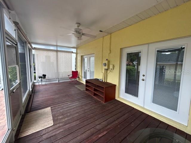 Back porch with sunscreens and two sets of entry doors into townhome.