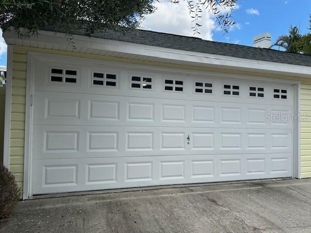 Rear facing garage off  alley with parking pad.