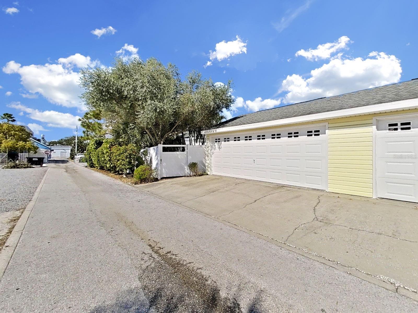 Public maintained alley with townhome garage access.