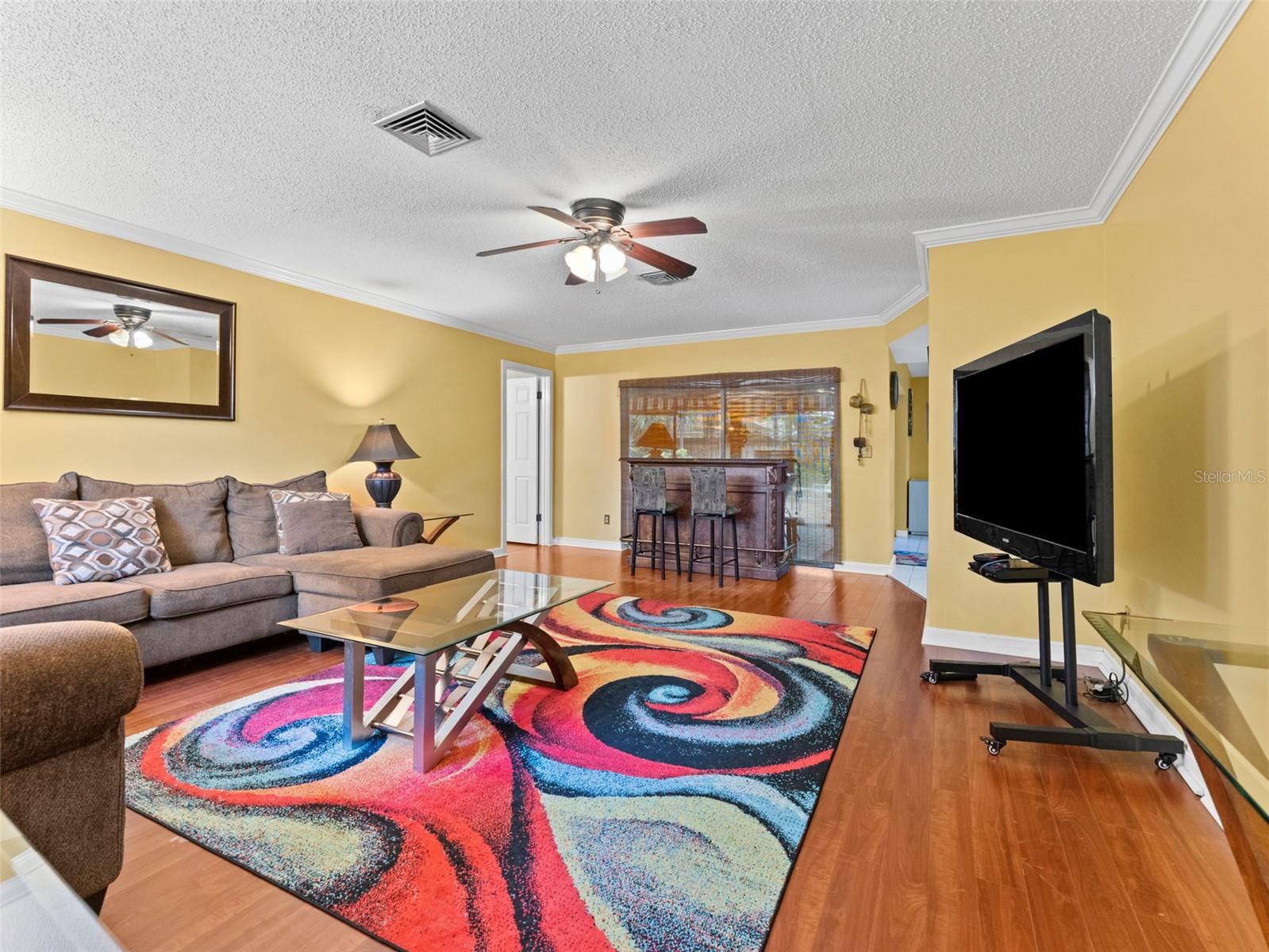 Living room overlooks screened patio & pool!