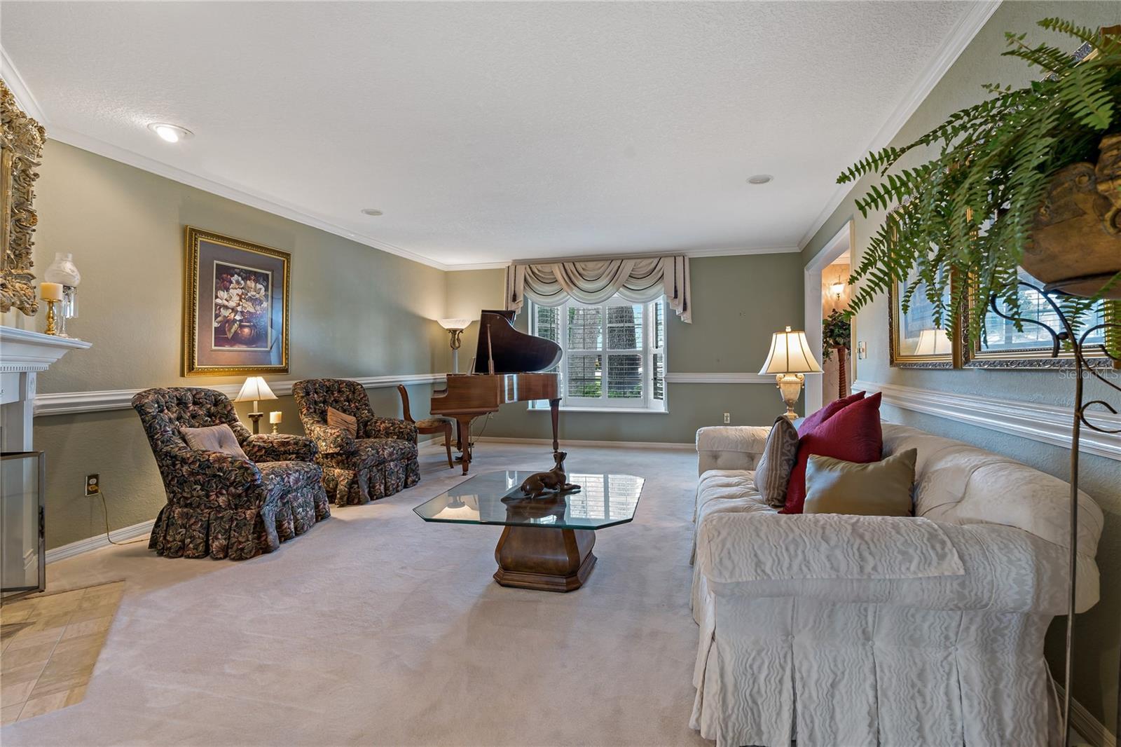 SPACIOUS FORMAL LIVING ROOM ACCENTED WITH BEAUTIFUL FLUTED, MOLDING IN ALL THE RIGHT PLACES