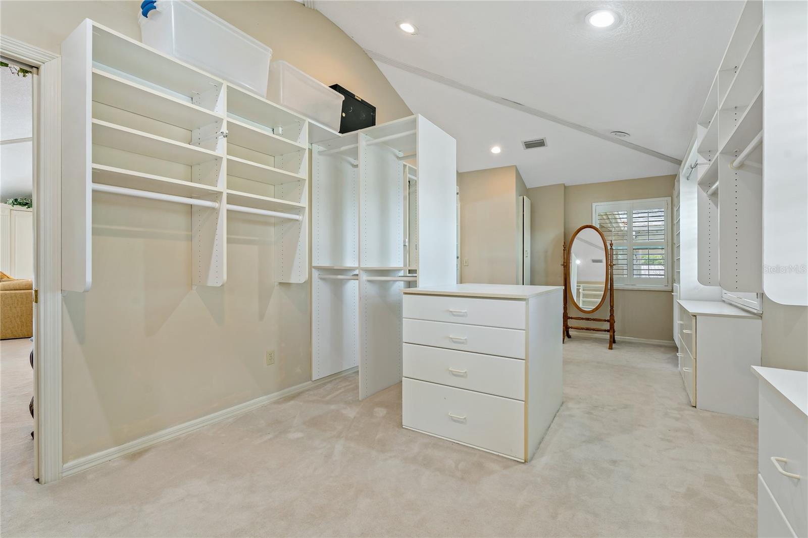 HUGE WALK IN CLOSET IN THE PRIMARY WITH CUSTOM STORAGE
