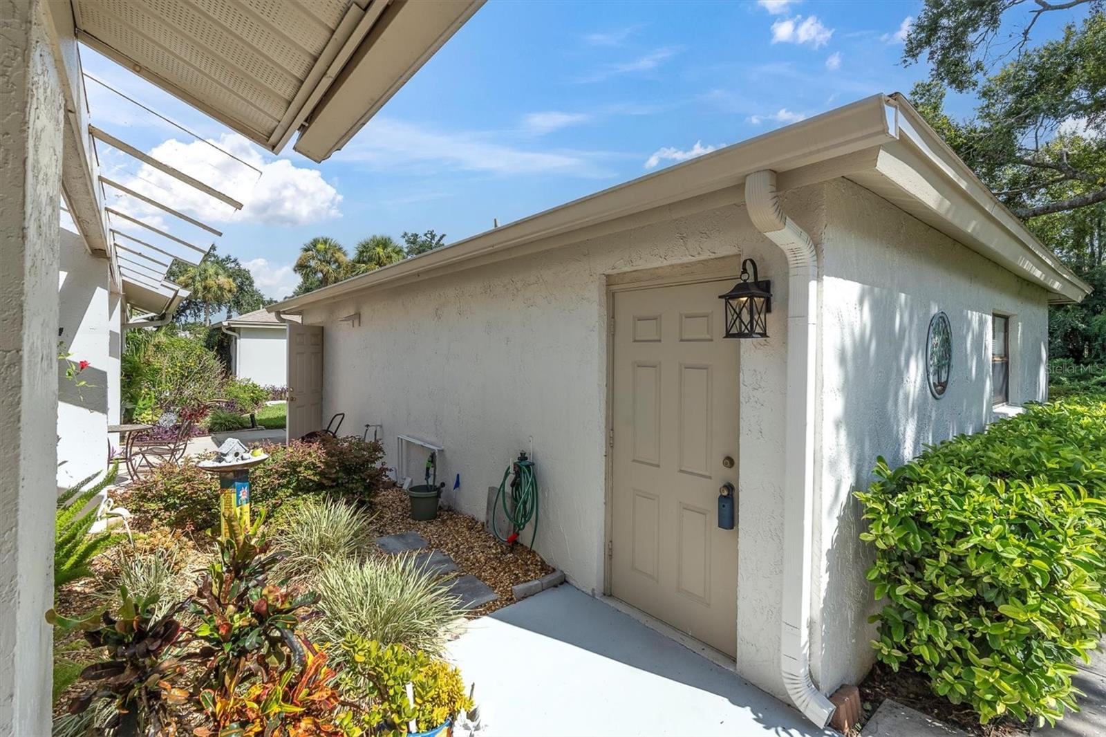 Entrance to detached garage steps from covcered front porch