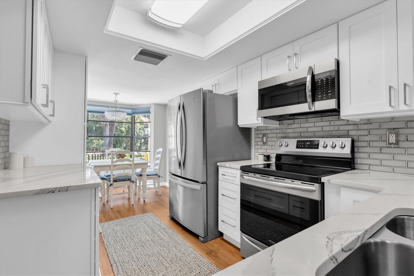 Beautiful new Kitchen with quartz counters, stainless appliances, and plenty of room for food prepping