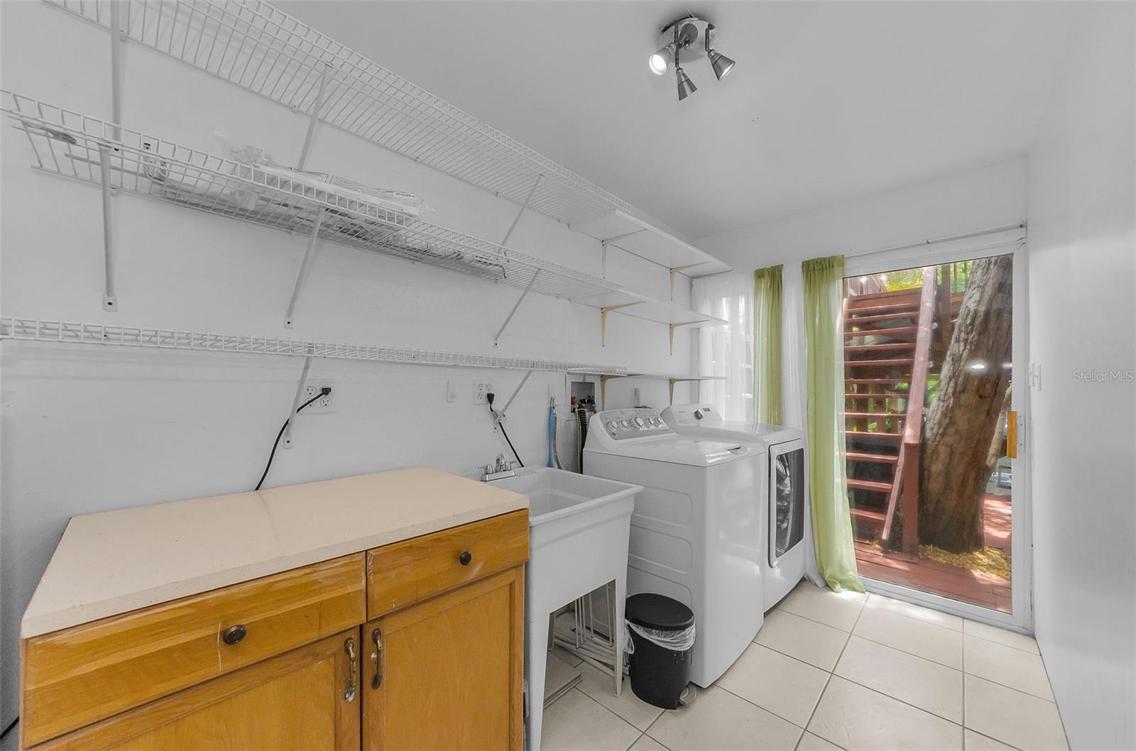 Laundry room with sliders leading to outside rear patio