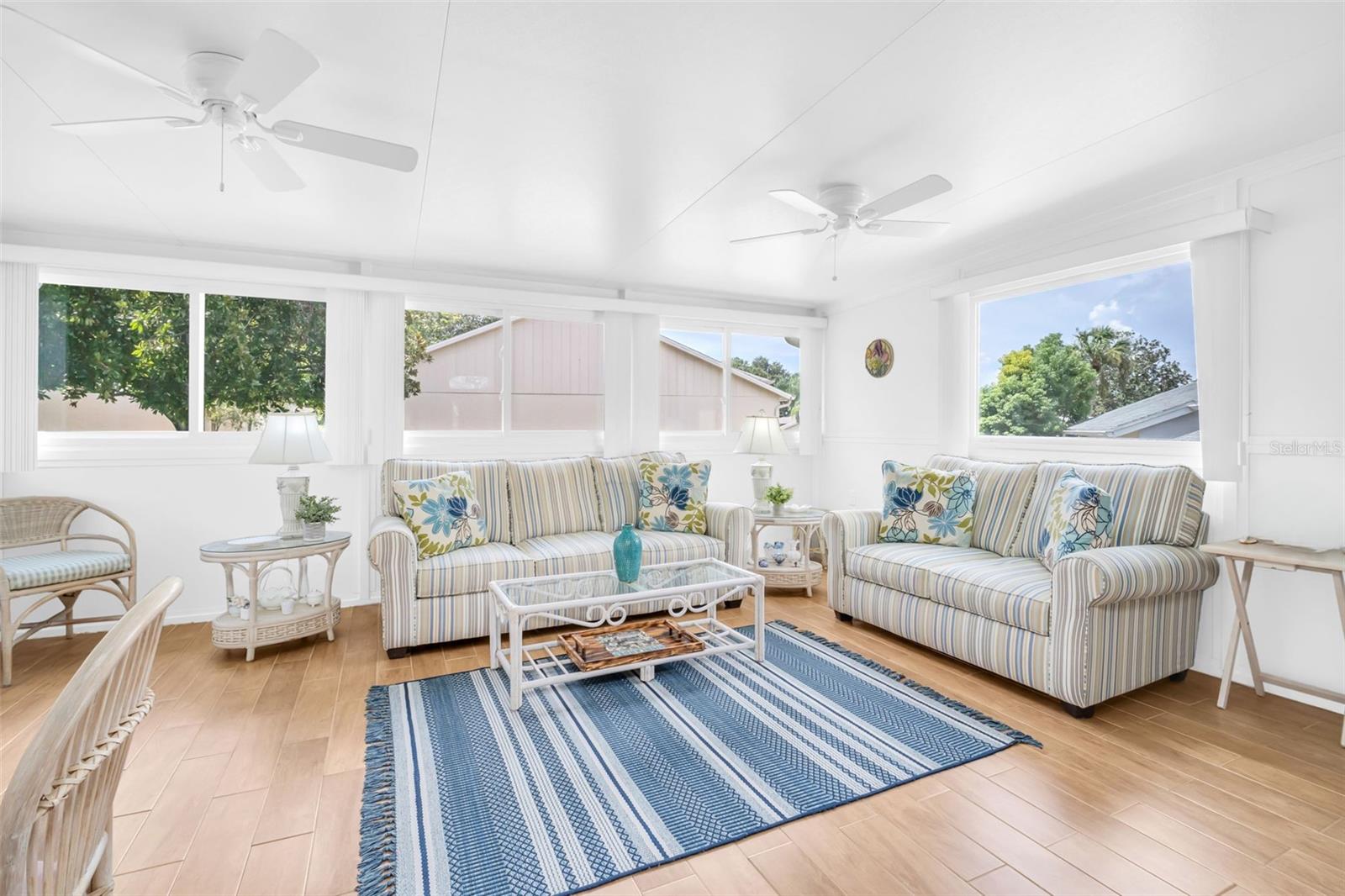 Large Florida room addition to enjoy year-round with wood-looking tile flooring~