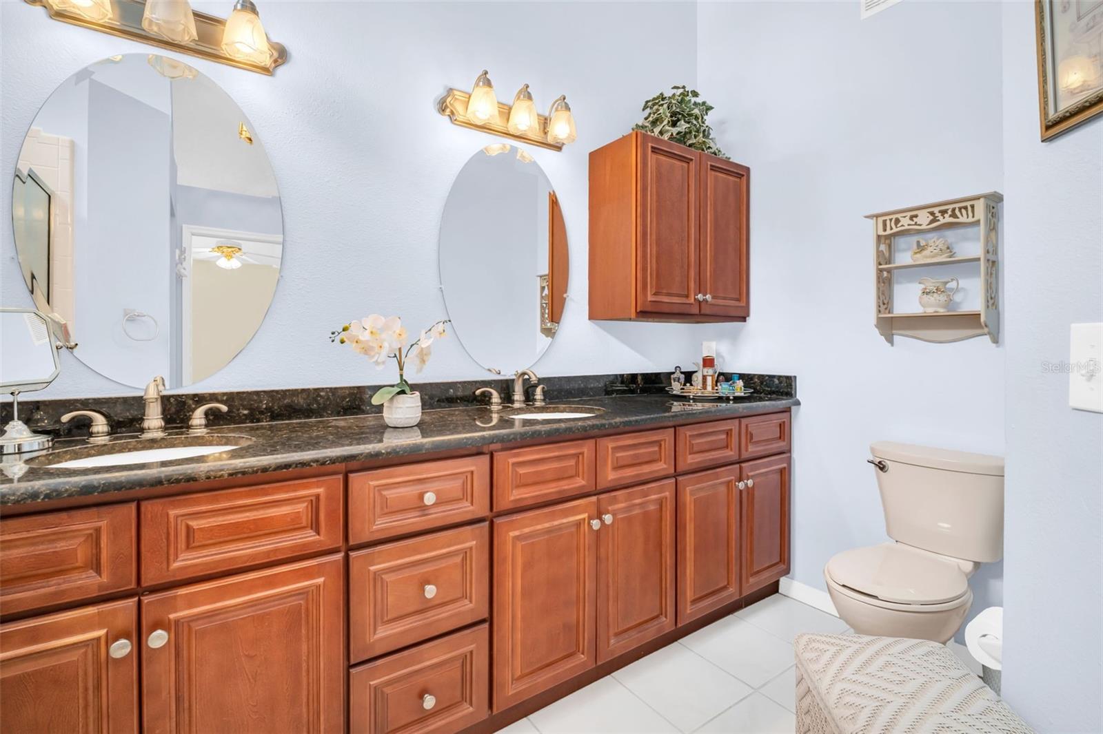Master en-suite featuring dual vanities, granite countertops, updated lighting & fixtures~