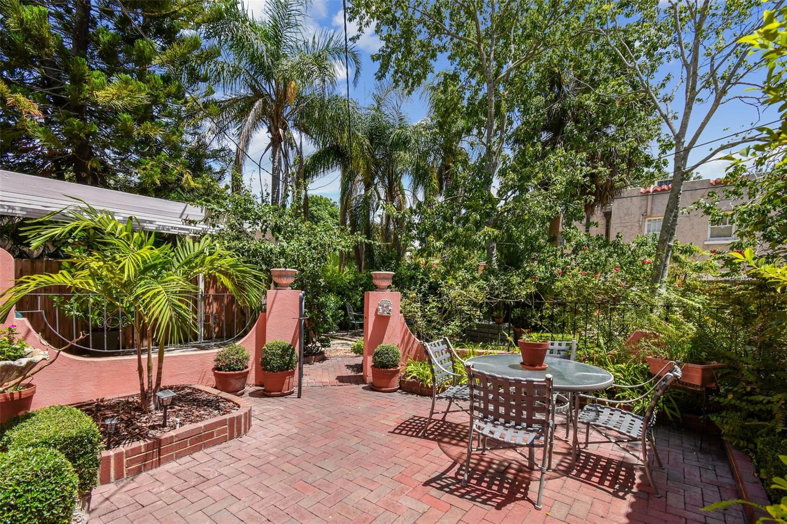 Courtyard with wrought iron gates to more green space