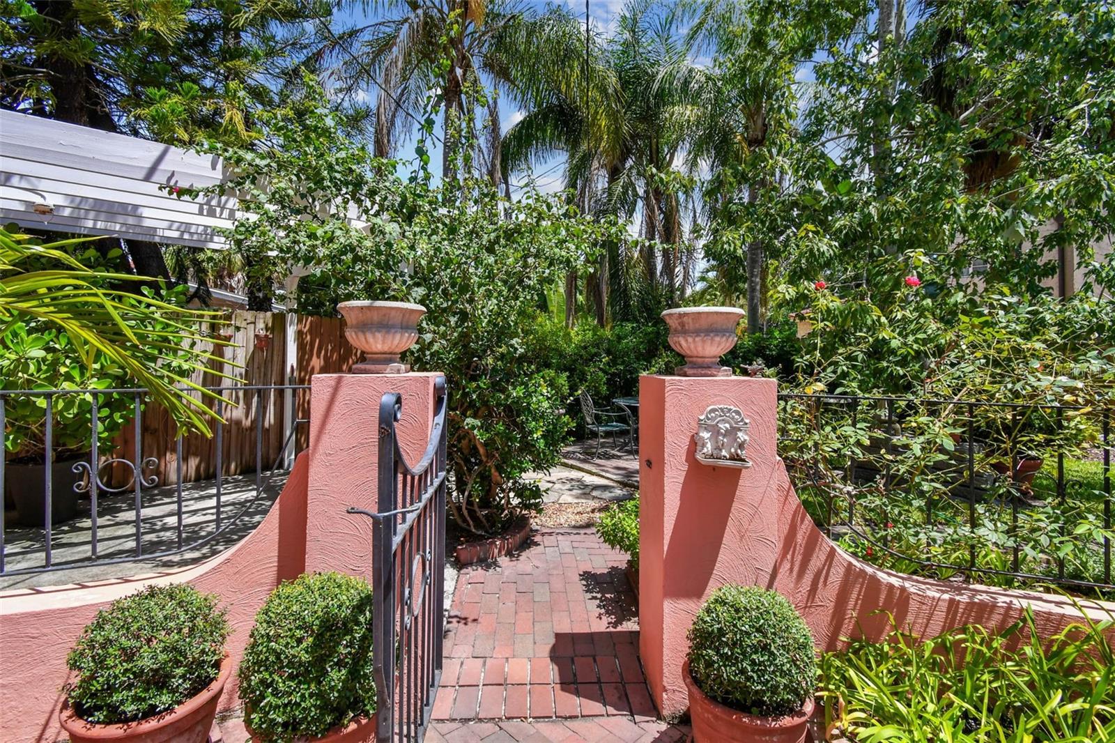 Leads you into another area of great backyard. Landscaping and brick walkway