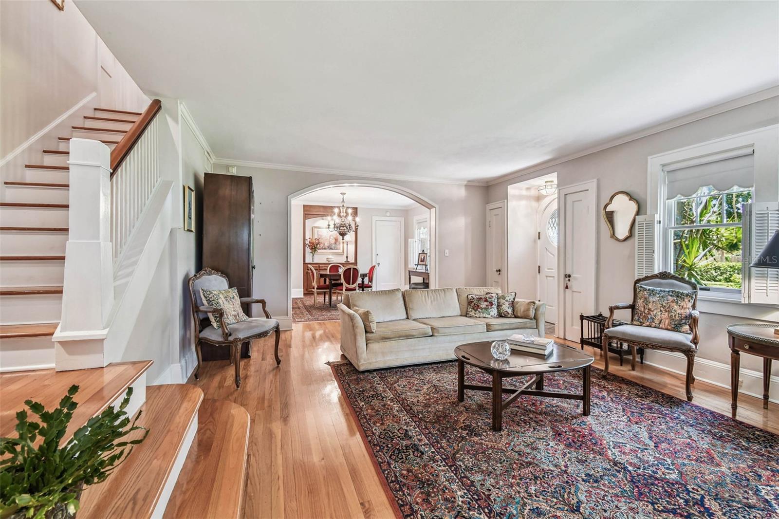 Large light-filled living room with beautiful oak floors.