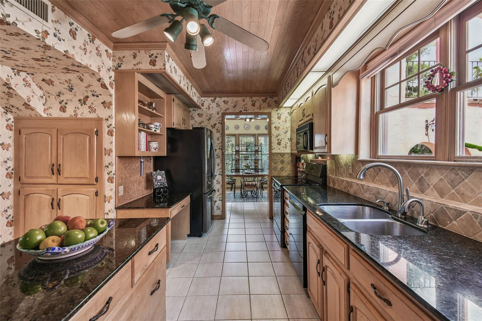 Big kitchen with wood cabinets and lots of countertop for food preparation